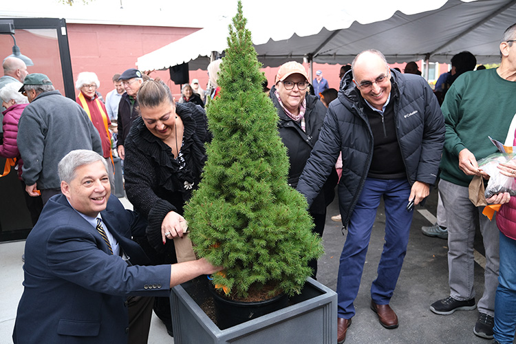 From left: Sen. Bruce Tarr, former Gloucester Mayor Sefatia Romeo Theken, Rep. Ann-Margaret Ferrante, and Gloucester Mayor Greg Verga help plant a community tree at The Open Door’s ribboncutting on Saturday. (Photo Courtesy of The Open Door) 