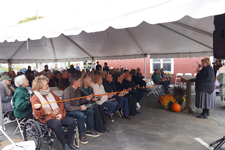 Orange ribbon was woven through the crowd for a collective, community ribbon-cutting on Saturday for The Open Door’s new Food and Nutrition Center. (Photo Courtesy of The Open Door) 